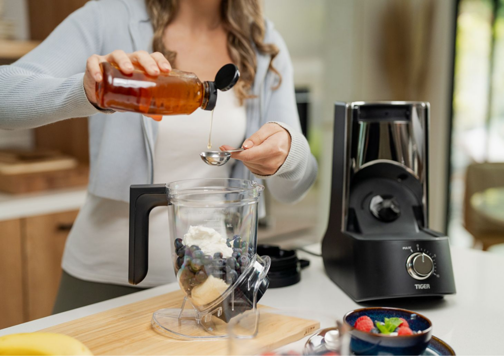 A fresh smoothie being whipped up smoothly inside a high-power kitchen blender.