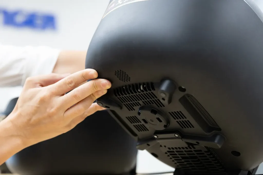 Showing the speaker located on the bottom of the rice cooker (JRT-A) by hand